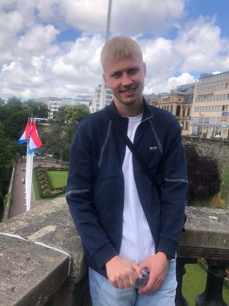 Ung mand på terrasse med byudsigt